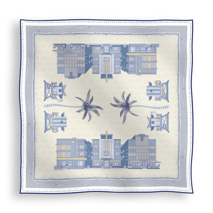 Cool Blue Miami Beach silk scarf featuring hand-drawn Art Deco buildings, iconic lifeguard towers, palm trees, and coastal scenery in shades of blue displayed in a lay-flat view.