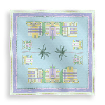 Pastel Miami Beach silk scarf featuring hand-drawn miami Art Deco buildings, iconic miami beach lifeguard towers, palm trees, coastal scenery, and a subtle shell pattern in pastel blue, green, purple, and yellow tones displayed in a lay-flat view.