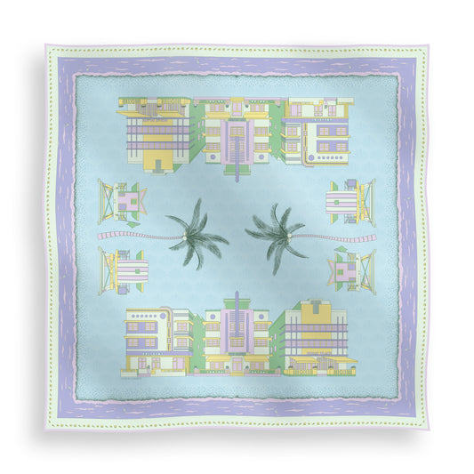 Pastel Miami Beach silk scarf featuring hand-drawn miami Art Deco buildings, iconic miami beach lifeguard towers, palm trees, coastal scenery, and a subtle shell pattern in pastel blue, green, purple, and yellow tones displayed in a lay-flat view.