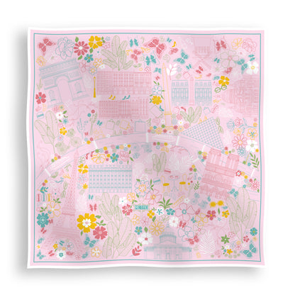 Rose Allure Paris silk scarf featuring a hand-drawn map of Paris with iconic landmarks including the Eiffel Tower, Arc de Triomphe, and Moulin Rouge on a light pink background with blue, green, and yellow accents displayed in a lay-flat view.
