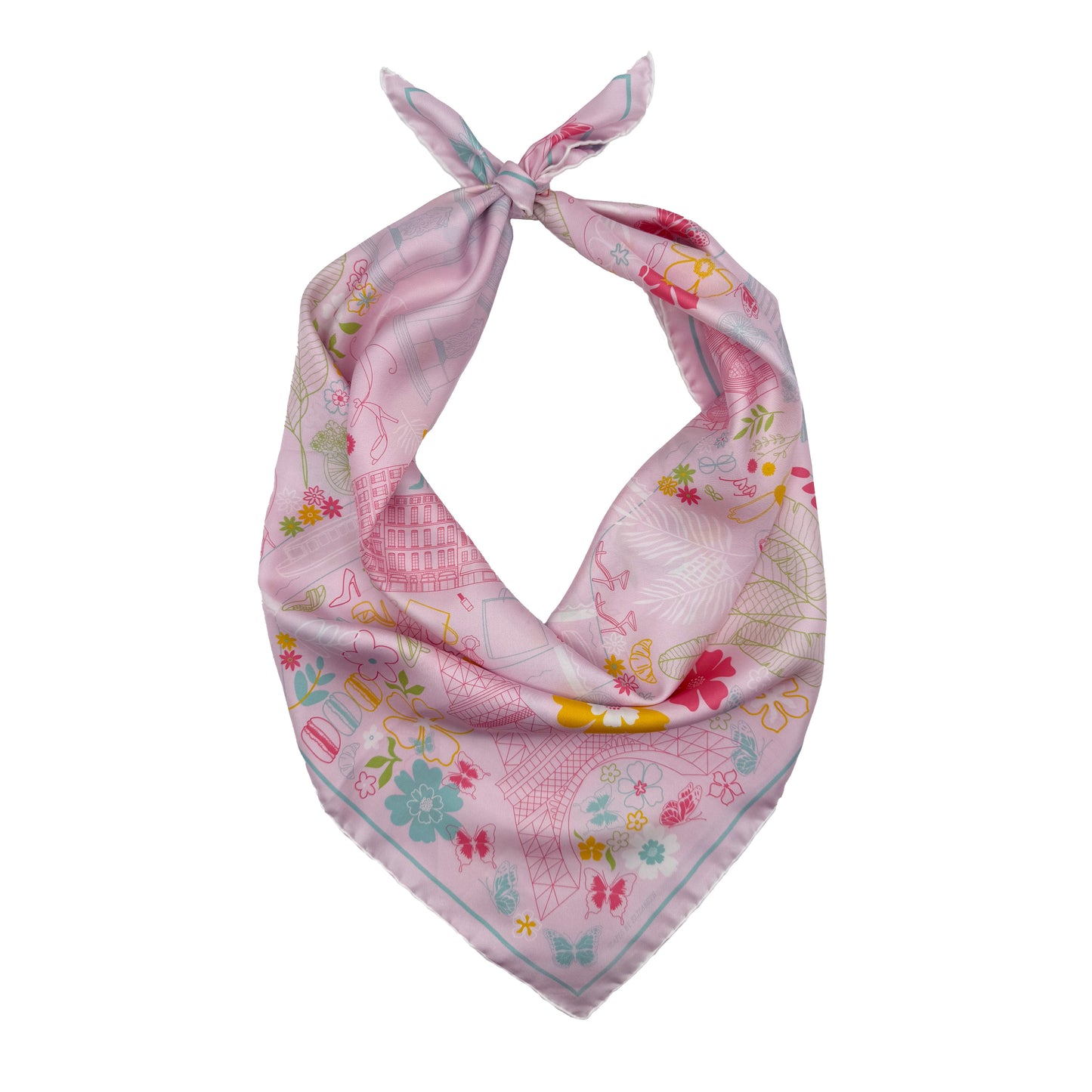 Rose Allure Paris silk scarf tied into a bandana featuring a hand-drawn map of Paris with the Eiffel Tower, Arc de Triomphe, Moulin Rouge, and colorful Paris-inspired artwork on a light pink background.