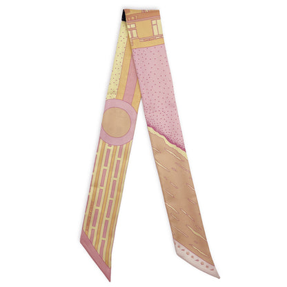 Miami Beach silk twilly in Sunset colorway featuring a geometric pattern inspired by Miami Beach Art Deco architecture in pink, yellow, and orange tones inspired by the colors of a Miami sunset.